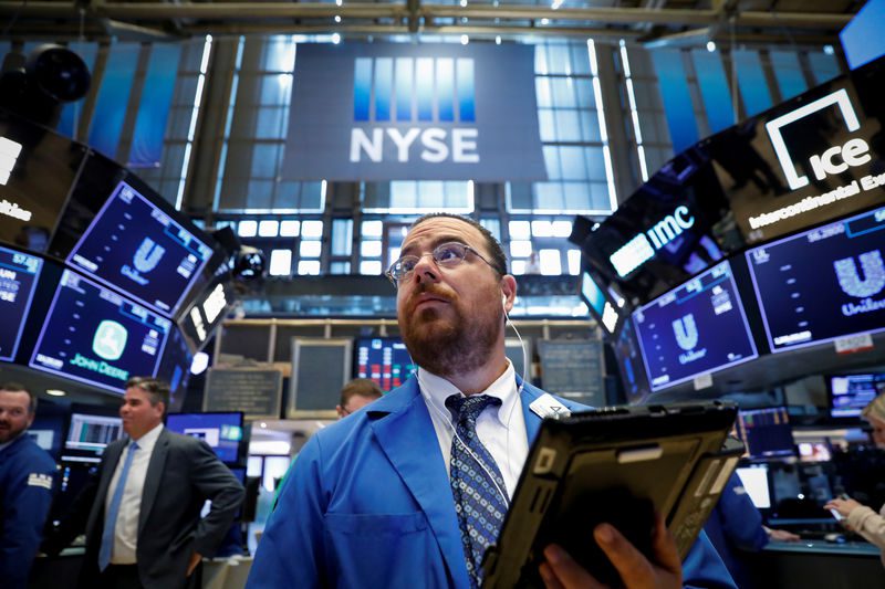 Traders work on the floor of the NYSE in New York